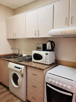 a kitchen with a sink and a stove top oven at ZenStay-Stylish Studio 1 Min to Metro in JLT in Dubai