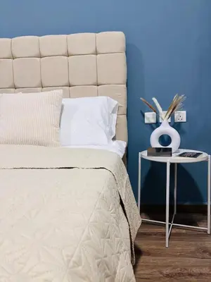 a bedroom with a large bed and a side table at ZenStay-Stylish Studio 1 Min to Metro in JLT in Dubai