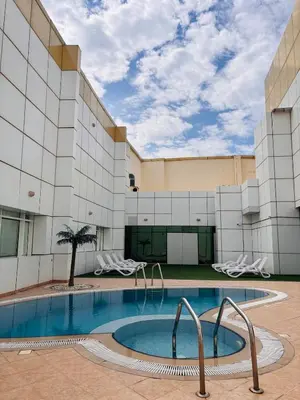 a swimming pool in front of a building at ZenStay-Stylish Studio 1 Min to Metro in JLT in Dubai