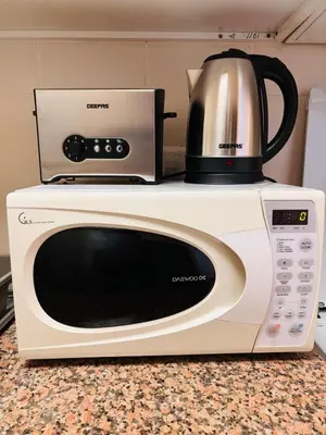 a microwave with a coffee pot on top of it at ZenStay-Stylish Studio 1 Min to Metro in JLT in Dubai