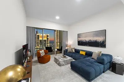a large living room with a blue couch and a living room at Luxury 1BR in Downtown l Close to Dubai Mall in Dubai