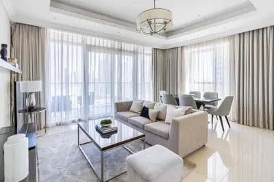 a living room with a couch and a table at The ME Apartment in Dubai