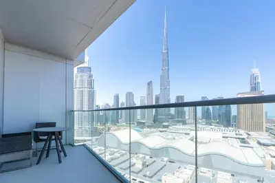 a room with a balcony with a view of a city at The ME Apartment in Dubai