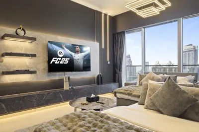 a living room with a tv on a wall at Luxury 1-Bedroom, High-Floor, Skyline Views in Dubai