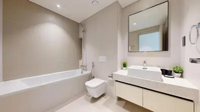 a bathroom with a sink toilet and a mirror at Marina Vista - Airy One Bedroom in Dubai Marina in Dubai