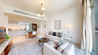 a living room with a couch and a table at Marina Vista - Airy One Bedroom in Dubai Marina in Dubai