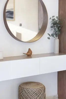 a bathroom with a round mirror and a stool at Lake View Studio near Marina with Pool, Balcony and Gym in Dubai