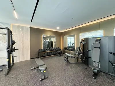 a gym with treadmills and equipment in a room at Waterfront Studio, perfectly located in Dubai Marina in Dubai
