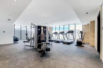 a gym with treadmills and ellipticals in a building at O Ten - Classy One Bedroom in Al Jaddaf in Dubai