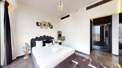 a bedroom with a white bed and a large window at O Ten - Classy One Bedroom in Al Jaddaf in Dubai