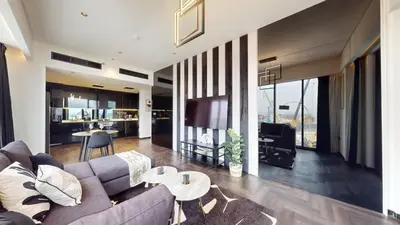 a living room with a couch and a table at O Ten - Classy One Bedroom in Al Jaddaf in Dubai