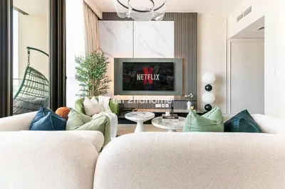 a living room with a couch and a tv at Luxurious Furnishing Direct Access to Dubai Mall in Dubai