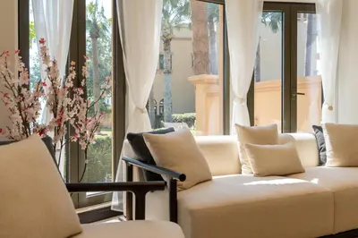 a living room with a couch in front of a window at Samaya Holiday Homes - Luxury Villa Pool - Beach Access & Fishing Zone in Dubai