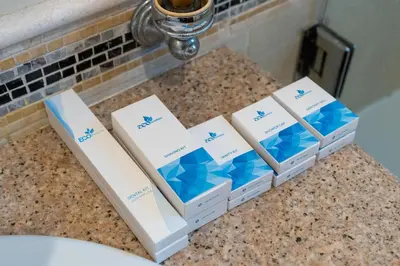 four boxes of toiletries sitting on a counter at Samaya Holiday Homes - Luxury Villa Pool - Beach Access & Fishing Zone in Dubai