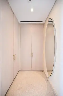 an empty room with a large round mirror at Stylish 1-BR Retreat with Sweeping Views in Palm Tower in Dubai