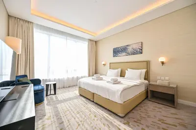 a hotel room with a bed and a television at Stylish 1-BR Retreat with Sweeping Views in Palm Tower in Dubai