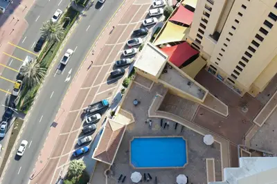 an overhead view of a parking lot with parked cars at Livbnb- Coastal 2B with Marina View Walk to Beach in Dubai