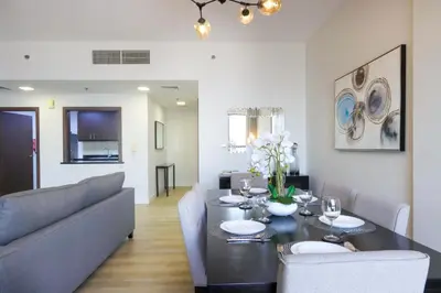 a living room with a table and a couch at Livbnb - High Floor 2B with Marina View Walk to Beach in Dubai