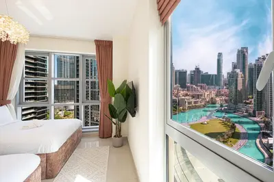a bedroom with a view of a city at Splendid 2BR Burj Khalifa & Fountain view in Dubai