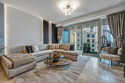 a living room with a couch and a table at JBR Coastal Escape - Amazing Sea Views, Pool & State-of-the-Art Gym in Dubai