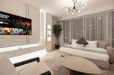 a living room with a bed and a tv at JBR Coastal Escape - Amazing Sea Views, Pool & State-of-the-Art Gym in Dubai