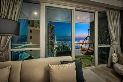 a living room with a couch and a large window at JBR Coastal Escape - Amazing Sea Views, Pool & State-of-the-Art Gym in Dubai