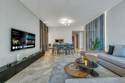 a living room with a couch and a table at JBR Coastal Escape - Amazing Sea Views, Pool & State-of-the-Art Gym in Dubai