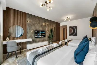 a hotel room with two beds and a mirror at JBR Coastal Escape - Amazing Sea Views, Pool & State-of-the-Art Gym in Dubai