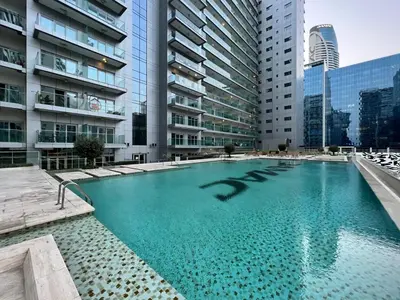 a swimming pool in a city with tall buildings at GuestReady - Luxe Comfort in Bussiness Bay in Dubai