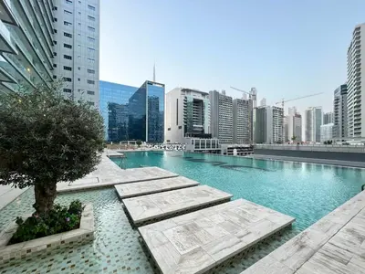 a large swimming pool in the middle of a city at GuestReady - Luxe Comfort in Bussiness Bay in Dubai