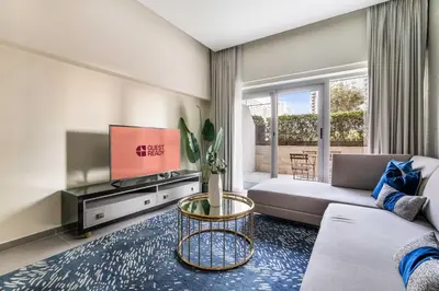 a living room with a couch and a tv at GuestReady - Luxe Comfort in Bussiness Bay in Dubai