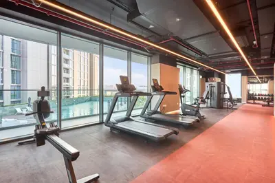 a gym with two treadmills and a pool at STAY BY LATINEM Luxury 1BR Holiday Home CVG 2409 Near Burj Khalifa in Dubai