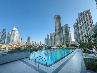 a swimming pool on the roof of a building with a city skyline at Maison Privee - Sky-High Elegance with Unrivaled Burj Khalifa Views in Dubai