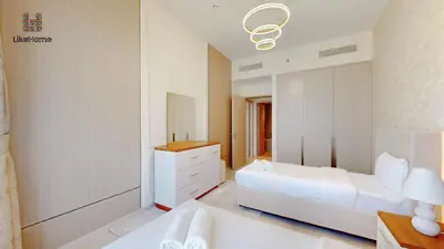 a white bedroom with a bed and a mirror at Enjoy Best Burj Khalifa & Fountain Views From Balcony Luxury 2BR 3 Mins from Dubai Mall - Like Home in Dubai