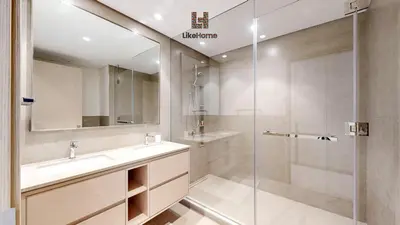 a bathroom with a sink and a glass shower at Enjoy Best Burj Khalifa & Fountain Views From Balcony Luxury 2BR 3 Mins from Dubai Mall - Like Home in Dubai