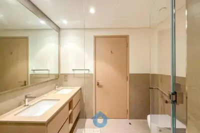 a bathroom with two sinks and a toilet and a mirror at Steps from Dubai Mall Enjoy Dubai Skyline from Balcony Luxury 2 Bedroom Like Home in Dubai
