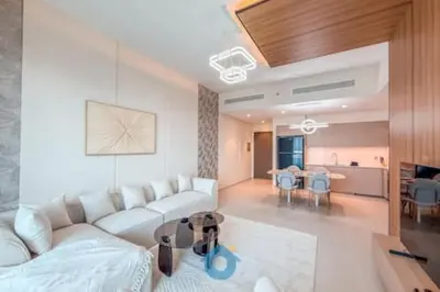 a living room with a white couch and a table at Steps from Dubai Mall Enjoy Dubai Skyline from Balcony Luxury 2 Bedroom Like Home in Dubai