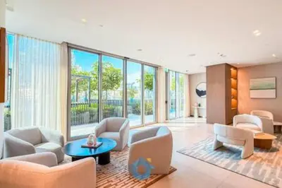 a living room with chairs and tables and windows at Next to Burj Khalifa & Dubai Mall - Enjoy Dubai Skyline Luxury 2BR Like Home in Dubai