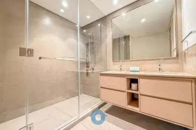 a bathroom with a shower and a sink and a mirror at Next to Burj Khalifa & Dubai Mall - Enjoy Dubai Skyline Luxury 2BR Like Home in Dubai