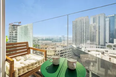 a balcony with a table with two mugs on it at GuestReady - Luxe Residence in Dubai Marina in Dubai