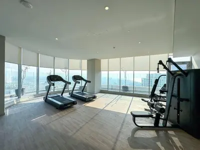 a gym with cardio equipment in a building with windows at GuestReady - Luxe Residence in Dubai Marina in Dubai
