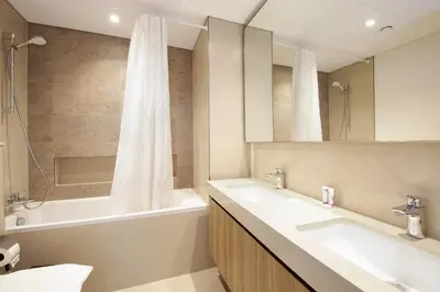 a bathroom with two sinks and a bath tub at Silk Valley - Luxury 2B with iconic Burj Khalifa views and walk to Dubai Mall in Dubai