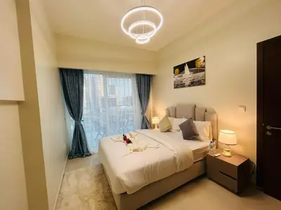 a bedroom with a bed and a large window at Luxurious 2bhk apartment in Business Bay in Dubai