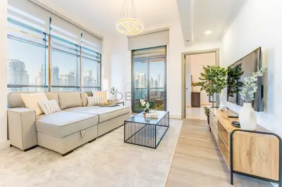 a living room with white furniture and large windows at Terrace and Marina Views 1BR Near JBR, Ain Dubai and Major Landmarks, Zumurud, Dubai Marina by Deluxe Holiday Homes in Dubai