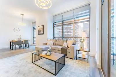 a living room with a couch and a table at Terrace and Marina Views 1BR Near JBR, Ain Dubai and Major Landmarks, Zumurud, Dubai Marina by Deluxe Holiday Homes in Dubai