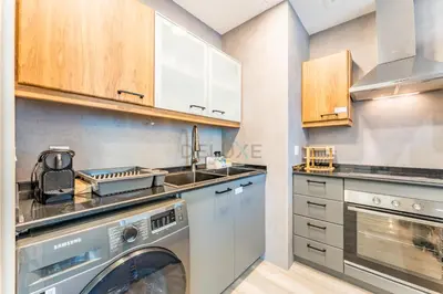 a kitchen with a washing machine and a sink at Terrace and Marina Views 1BR Near JBR, Ain Dubai and Major Landmarks, Zumurud, Dubai Marina by Deluxe Holiday Homes in Dubai
