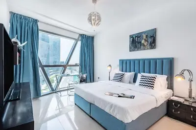 a bedroom with a bed and a large window at Luxury 2BR Stay in DIFC, Steps to Gate Avenue and Dubai Mall in Dubai
