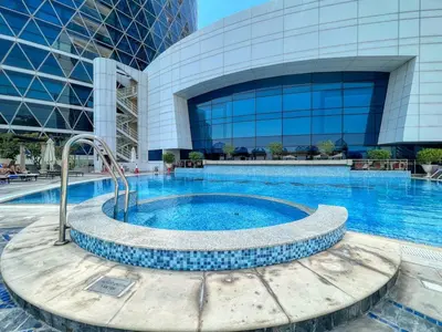 a swimming pool in front of a building at Luxury 2BR Stay in DIFC, Steps to Gate Avenue and Dubai Mall in Dubai