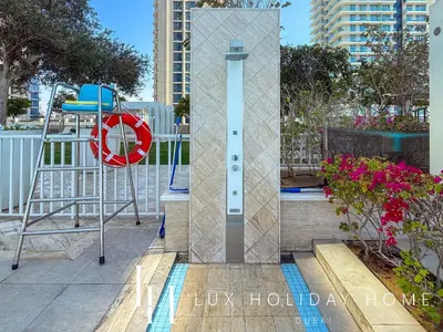 a pool with a life preserver and a swing on a balcony at LUX The Beach Vista Dubai Eye View Suite in Dubai