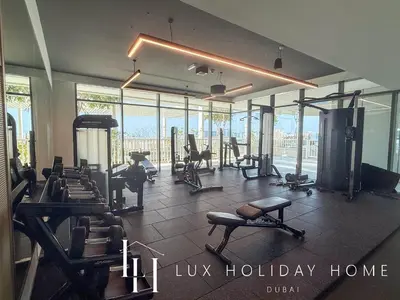 a gym with lots of equipment in a building at LUX The Beach Vista Dubai Eye View Suite in Dubai
